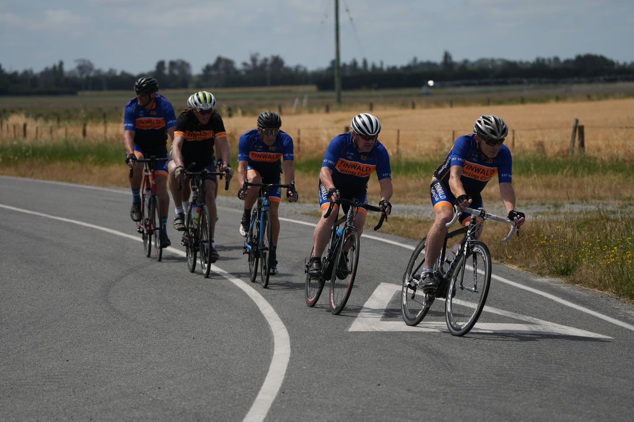 Tinwald club riders together on a quiet road through Canterbury farmland